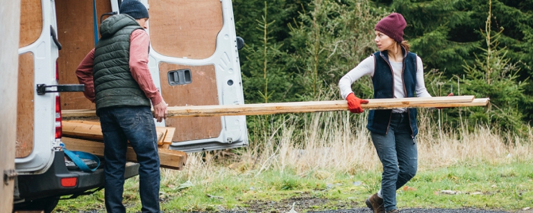 Builders taking materials out of a van